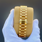 Tissot PRX gold president bracelet side view dark grey background