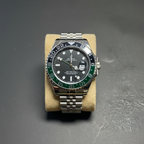 GMT style watch with green black Sprite bezel flat lay overhead shot