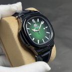 Professional photo of full black nautilus watch with green dial on velvet cushion