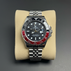 GMT style watch with red black Pepsi bezel flat lay overhead shot