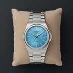 Tissot PRX style watch ice blue dial flat lay overhead shot